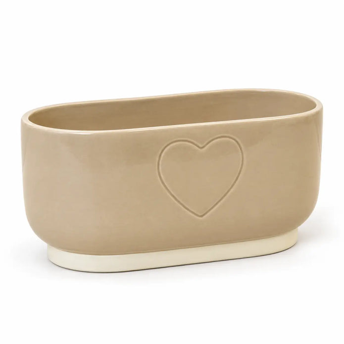 Empty beige ceramic heart planter with cream base on a white background