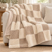 Riva Home beige and cream fur boucle check blanket throw draped over a sofa