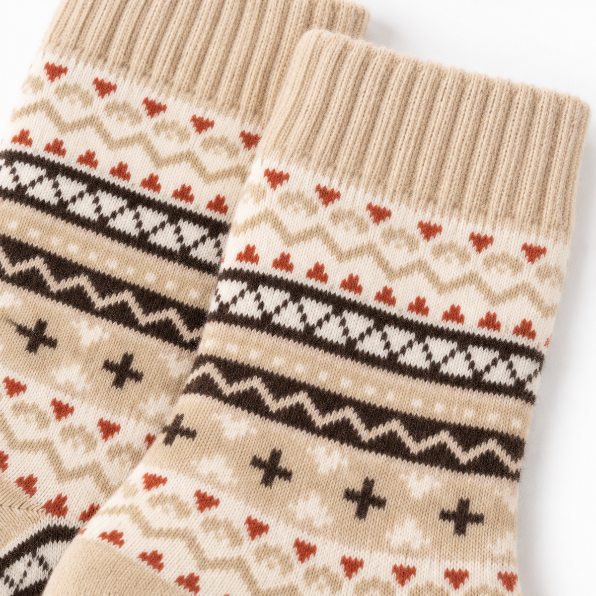 Close-up of beige, brown and rust Nordic knit pattern on cosy socks