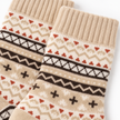 Close-up of beige, brown and rust Nordic knit pattern on cosy socks