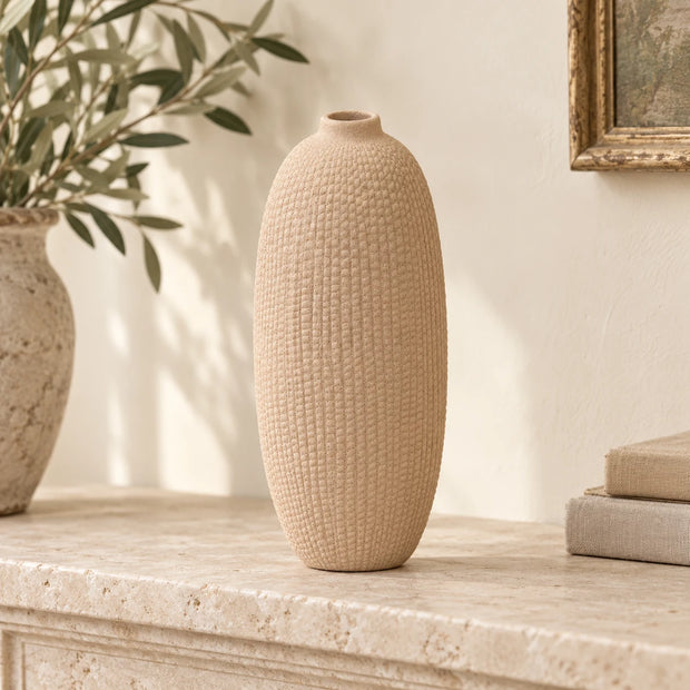 Beige textured stone vase by Satchville, decorative vase with a natural finish, shown on a mantel.