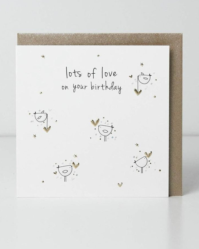 Belly Button Designs birthday greeting card titled "Lots of Love" with colorful heart illustrations and cheerful design.