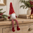 Sitting Red Woolly Christmas Gonk styled on an oak console