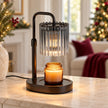 Black candle warmer lamp with smoky crystal-style glass shade on a cream console