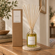 Black Oud Reed Diffuser styled on an oak console with natural reeds inserted.
