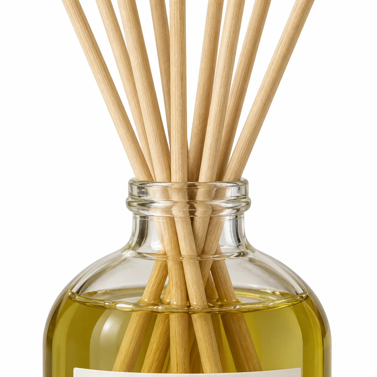 Black Oud Reed Diffuser close-up of natural rattan reeds and the glass bottle neck.