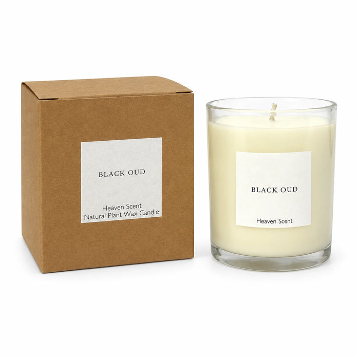 Heaven Scent Black Oud Medium Candle unlit with its kraft box on white