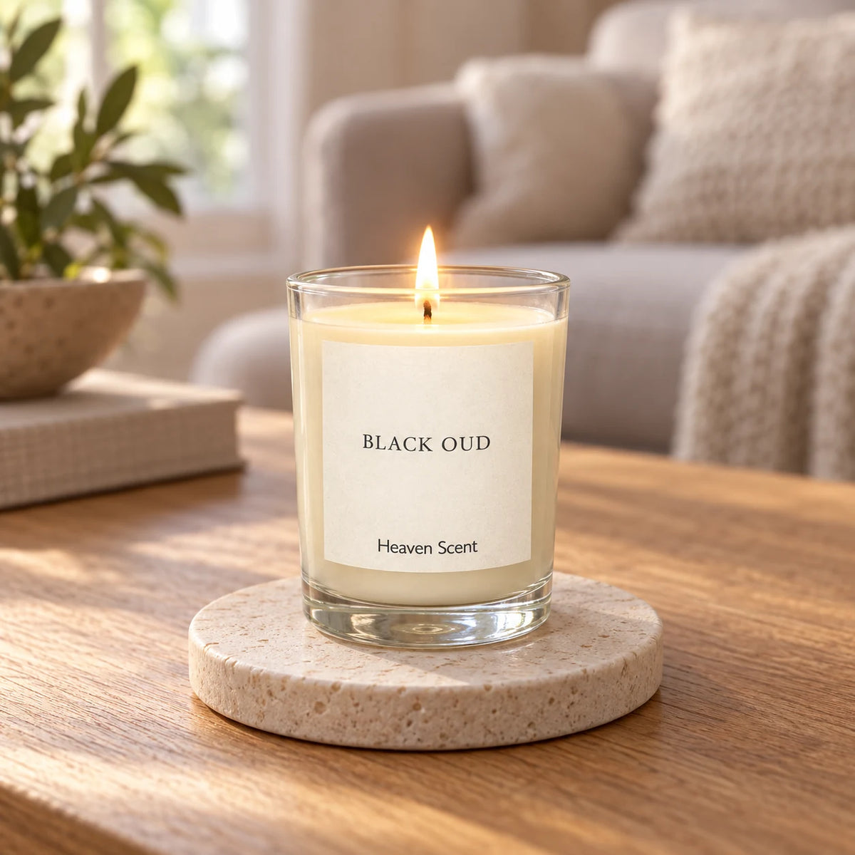 Heaven Scent Black Oud Small Candle lit on a stone coaster in a living room