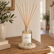Black Pomegranate Reed Diffuser styled on an oak console with natural reeds inserted.