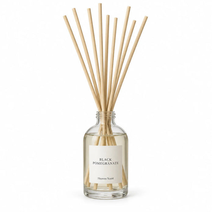 Black Pomegranate Reed Diffuser on white with natural reeds inserted.