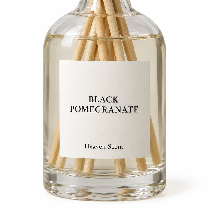 Black Pomegranate Reed Diffuser close-up of the fragrance label and glass bottle.