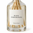 Black Pomegranate Reed Diffuser close-up of the fragrance label and glass bottle.