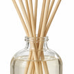 Black Pomegranate Reed Diffuser close-up of natural rattan reeds and the glass bottle neck.