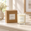 Heaven Scent Black Pomegranate Medium Candle with its kraft box on a console