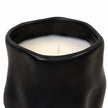 Close-up of the candle's wavy black rim, ivory wax and single unlit wick