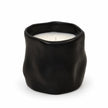 Full black sculpted candle with white wax and unlit wick on a white background