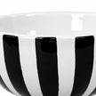 Close-up of glossy black and white stripes and the bowl's plain white interior