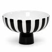 Full black and white striped ceramic bowl with solid black foot on a white background