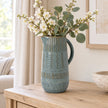 Large 32cm blue ceramic jug with mottled glaze and textured bands, console view.
