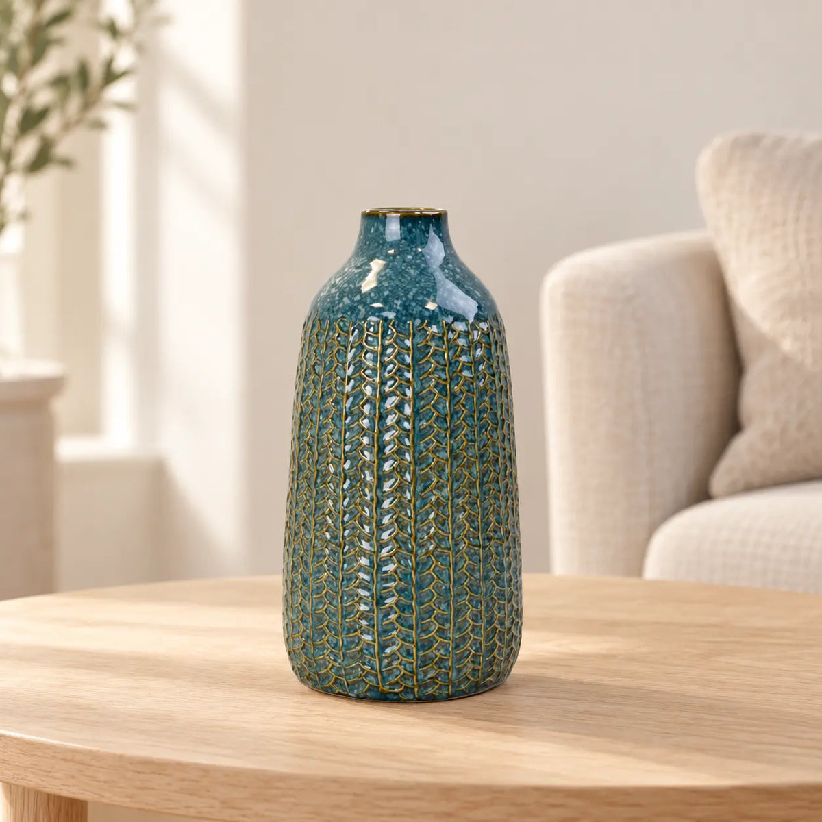 Medium blue ceramic vase on an oak side table in a neutral living room.