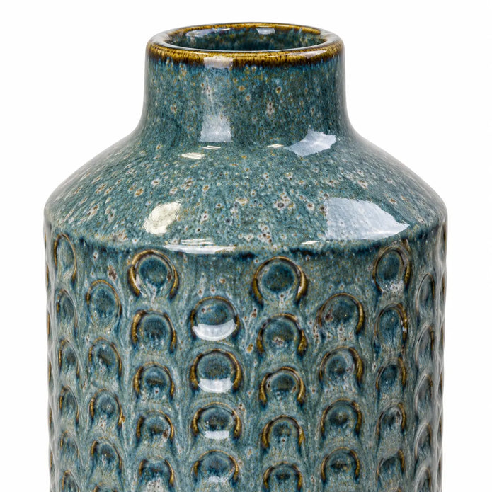 Small blue ceramic vase close-up of the glazed neck and textured ceramic body.