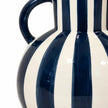 Studio view of glossy navy and white stripes and curved handles on a ceramic vase