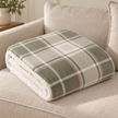 Riva Home Braemar check Sherpa fleece throw in green and natural, folded neatly