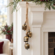 Four-bell hanging garland styled at the end of a Christmas mantel