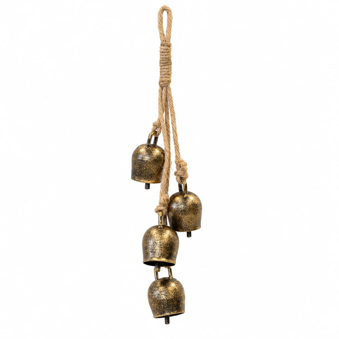 Four antiqued brass-toned cowbells on a rope hanging garland, white studio background