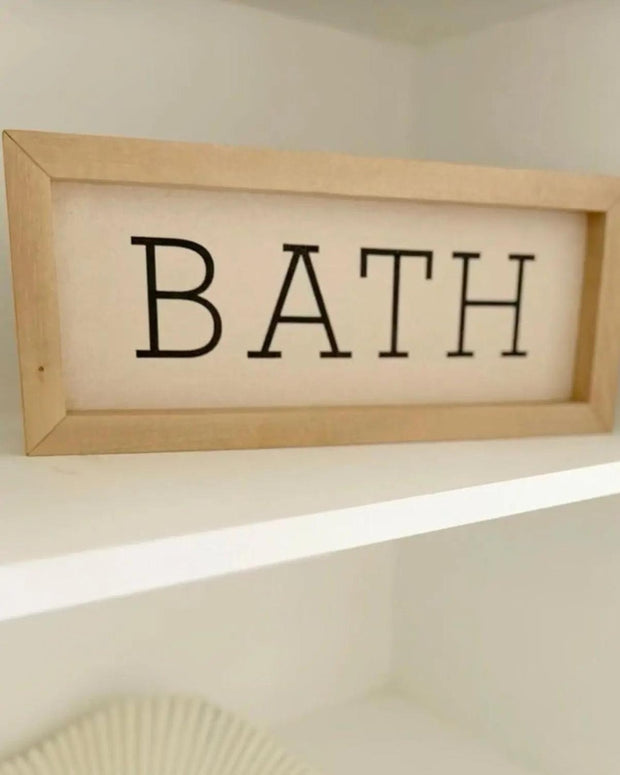 Rustic wooden framed wall art sign with "BATH" in black lettering by Brayden and Brooks, suitable for bathroom decor.