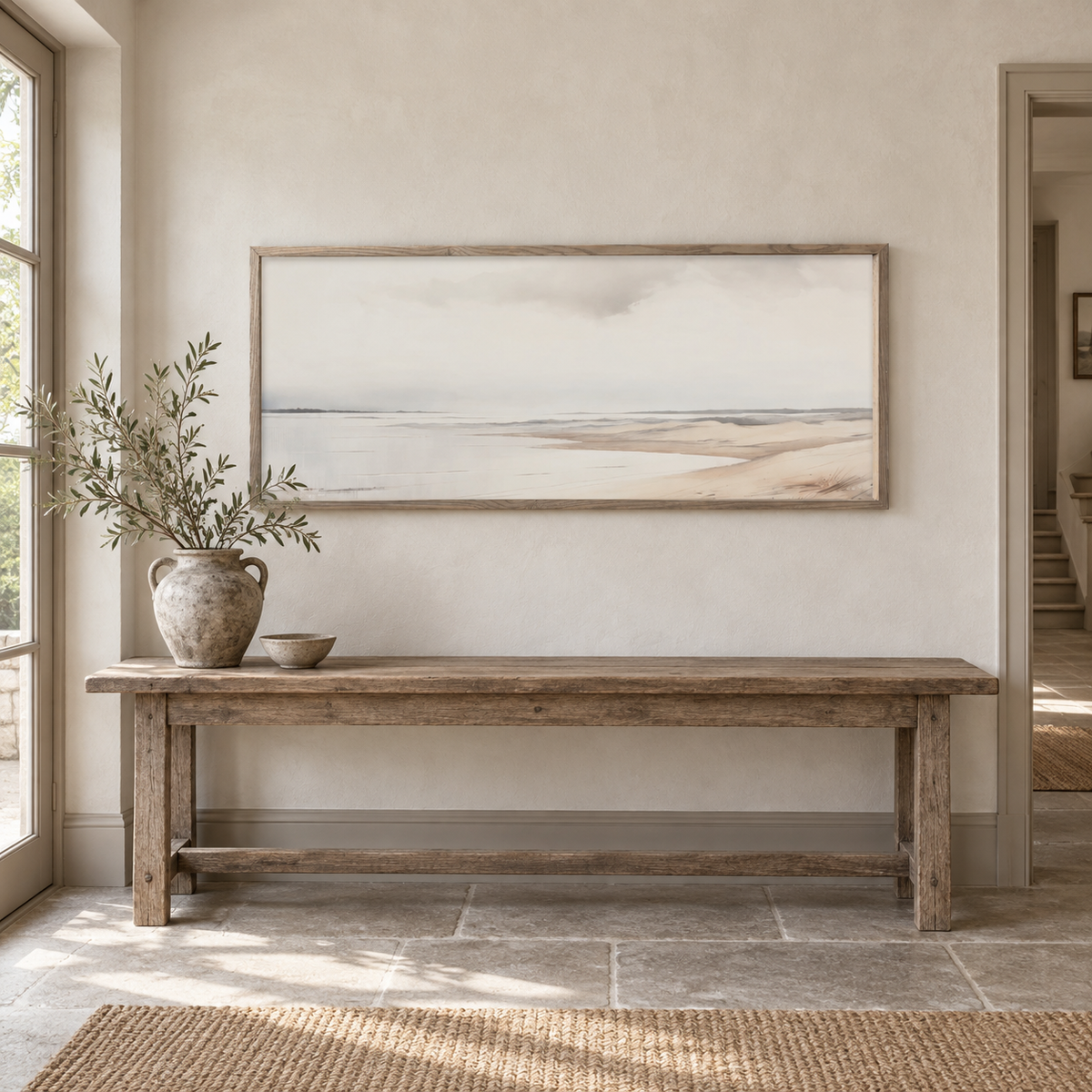 Brayden and Brooks extra large Seagrass framed canvas styled above an aged oak bench in a classic modern country hallway.