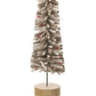 Close-up of curled brown felt strips small red berry details and wooden base of Christmas tree