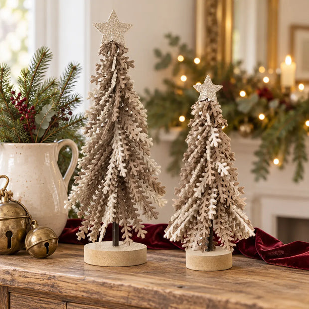 Small and large brown felt Christmas trees with gold stars on a festive oak console