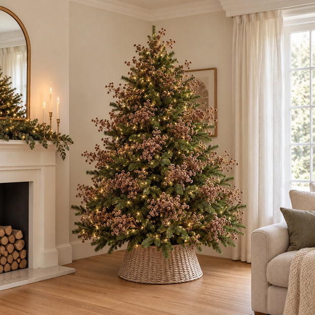 Green Christmas tree with lights and multiple brown gypsophila stems before adding baubles.