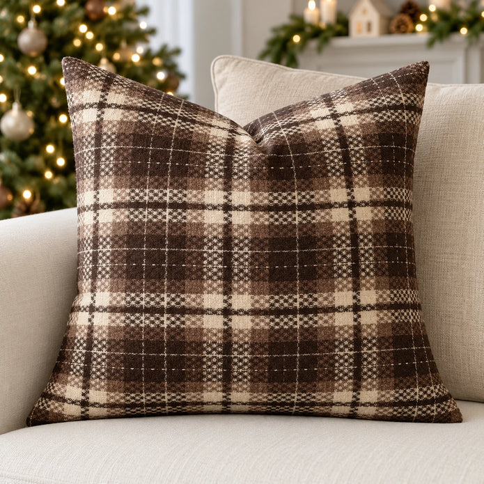 Brown tweed tartan cushion cover on a cream sofa with neutral Christmas decorations