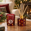 Burgundy stockings and baubles diffuser and candle gift set with festive holiday decor and fragrant candles, lifestyle scene.