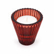 Close-up of burgundy ribbed glass holder with a white tealight