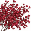 Studio detail of burgundy artificial gypsophila flowers on dark branching stems against white.