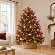 Burgundy gypsophila stems in a finished green Christmas tree with lights and neutral baubles.
