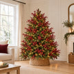 Green Christmas tree dressed with lights and multiple burgundy gypsophila stems before baubles.