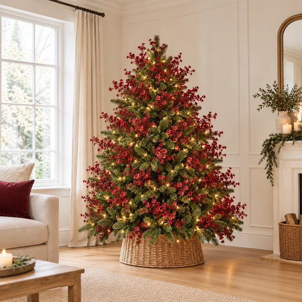 Green Christmas tree dressed with lights and multiple burgundy gypsophila stems before baubles.