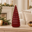 Large burgundy ribbed ceramic Christmas tree with cream star on an oak console