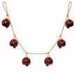Burgundy metal bell garland with six bells on rustic rope, full product on a white background