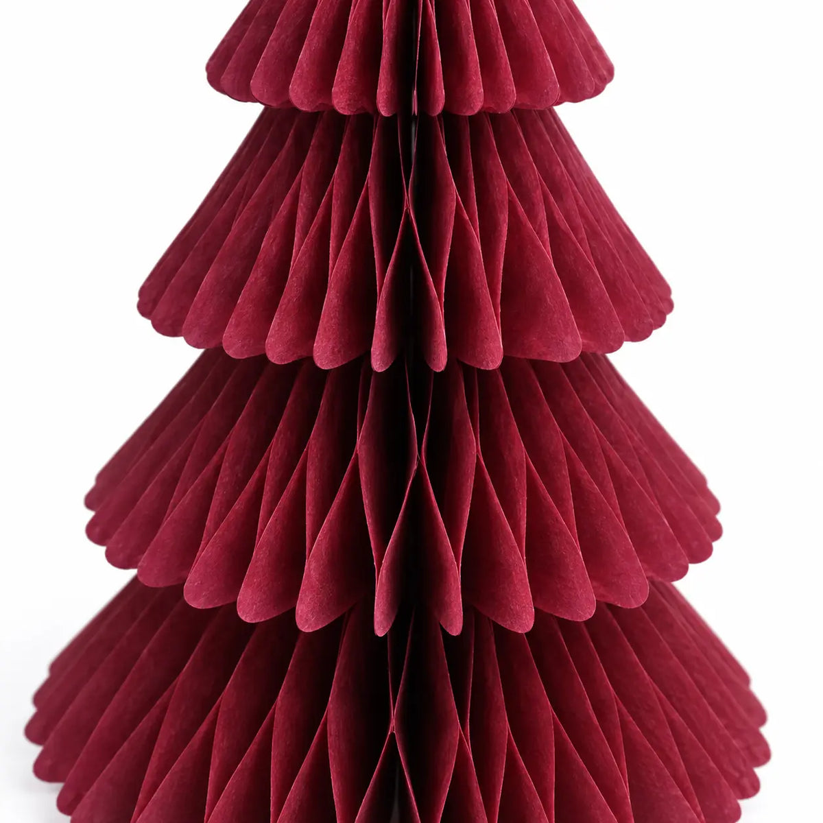 Close-up of claret red folded paper and scalloped tier edges on the Christmas tree.