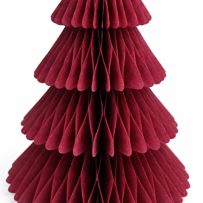 Close-up of claret red folded paper and scalloped tier edges on the Christmas tree.