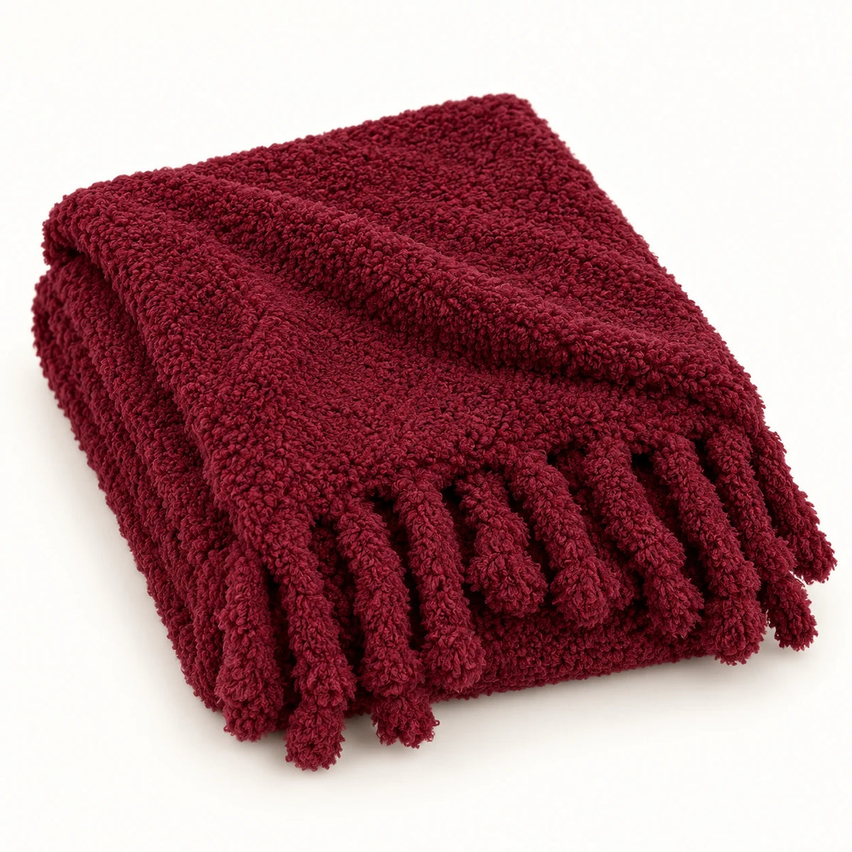 Burgundy Sherpa Tasselled Blanket Throw from Riva Home, soft and cozy with tassel accents for stylish comfort.