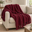 Burgundy Sherpa Tasselled Blanket Throw by Riva Home, soft and cozy with tassel accents, perfect for added warmth and style.
