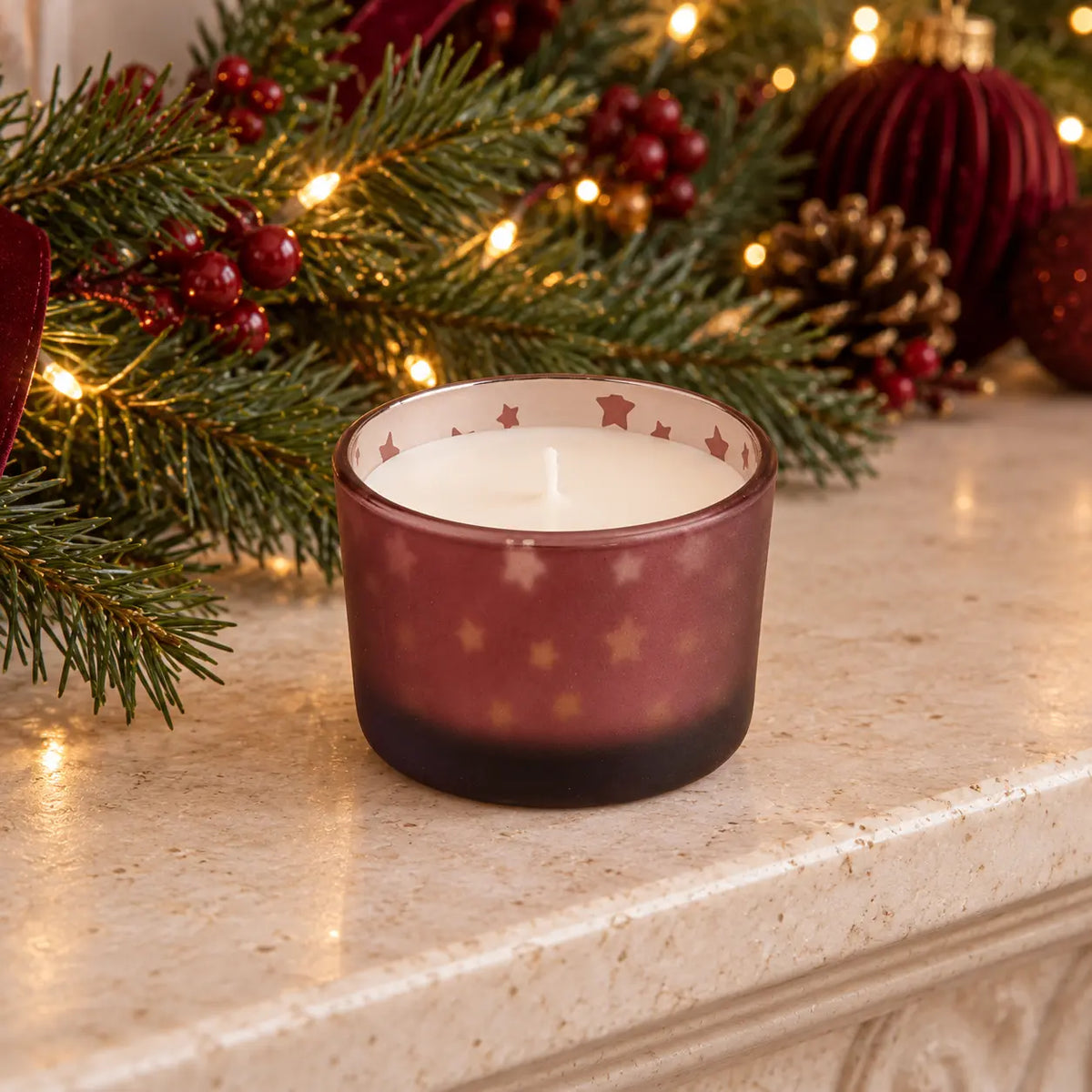 Burgundy red Christmas stockings and baubles candle on a mantel, festive holiday decor by Candlelight Products Ltd