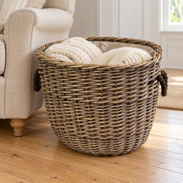 Satchville Burley Log Basket with hessian liner and rope handles, designed for storing firewood or blankets in a rustic setting.