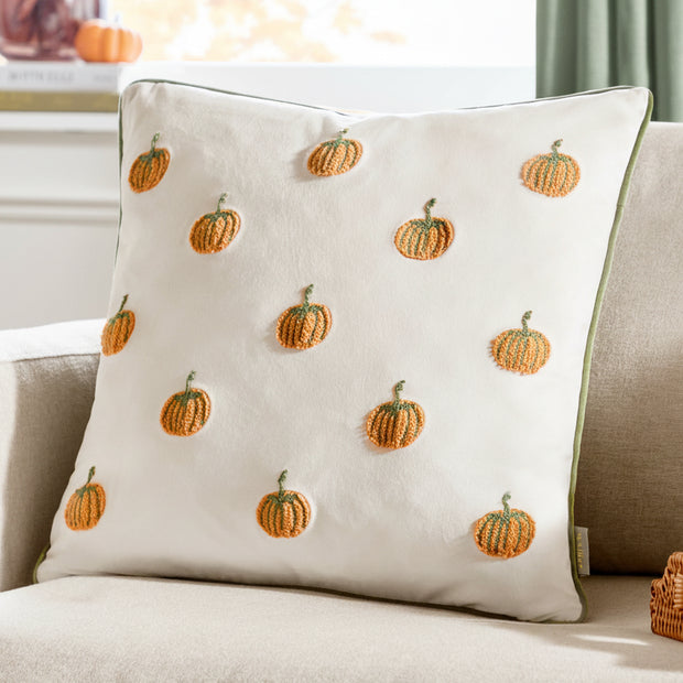 Decorative pillow with pumpkin pattern on a couch